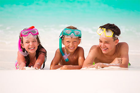 Kids on the beach with swim goggles